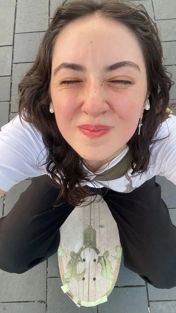 Playful Perspectives: A Skateboarder''s Top-Down Smile